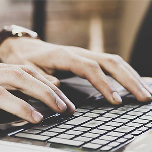 Hands typing on keyboard