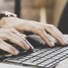 Hands typing on keyboard